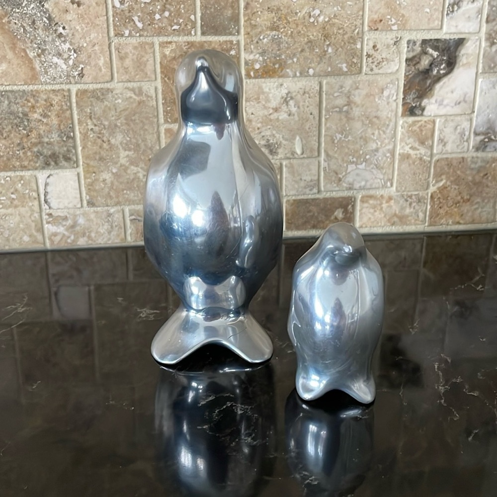Set of Hoselton Canada penguin cast aluminum sculptures.